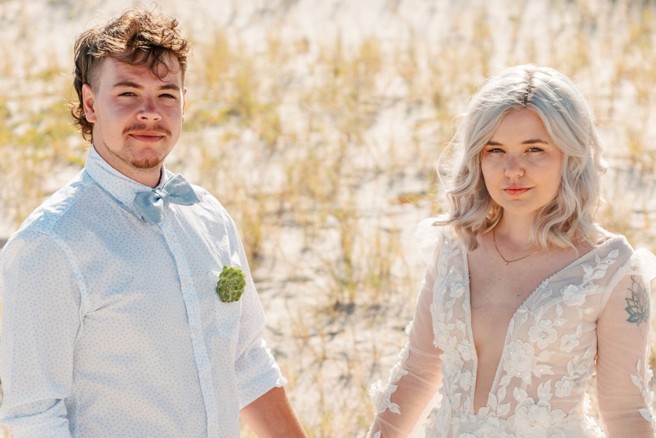 Naturallow Owners Camilla and Dylan Sexton on the beach in formal attire - cropped version