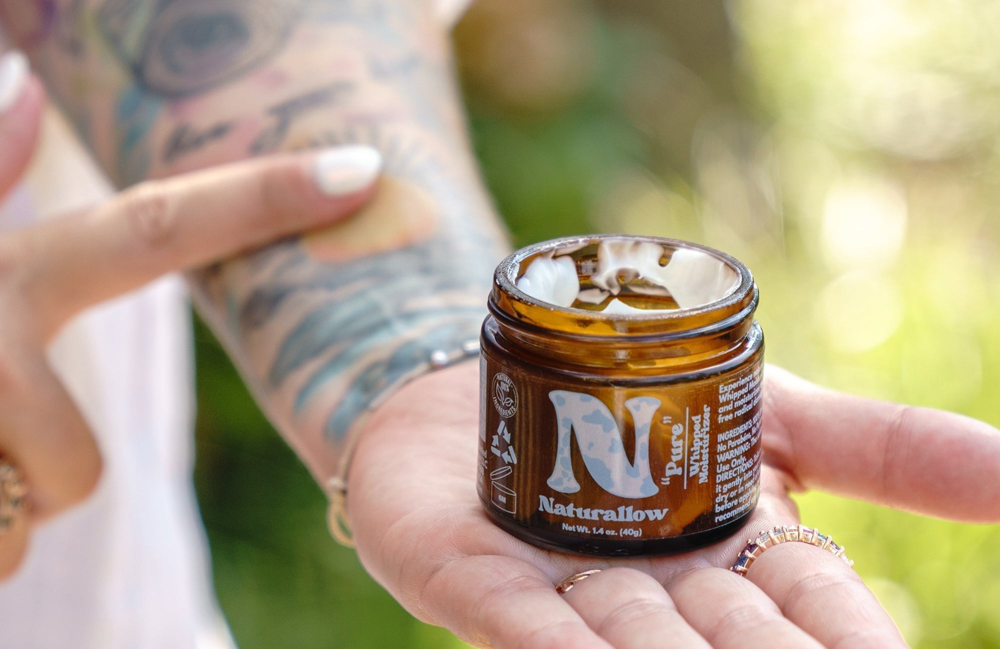 Naturallow's Tallow for Tattoos Blog Post Cover showing Tallow Balm being applied to a tattooed arm
