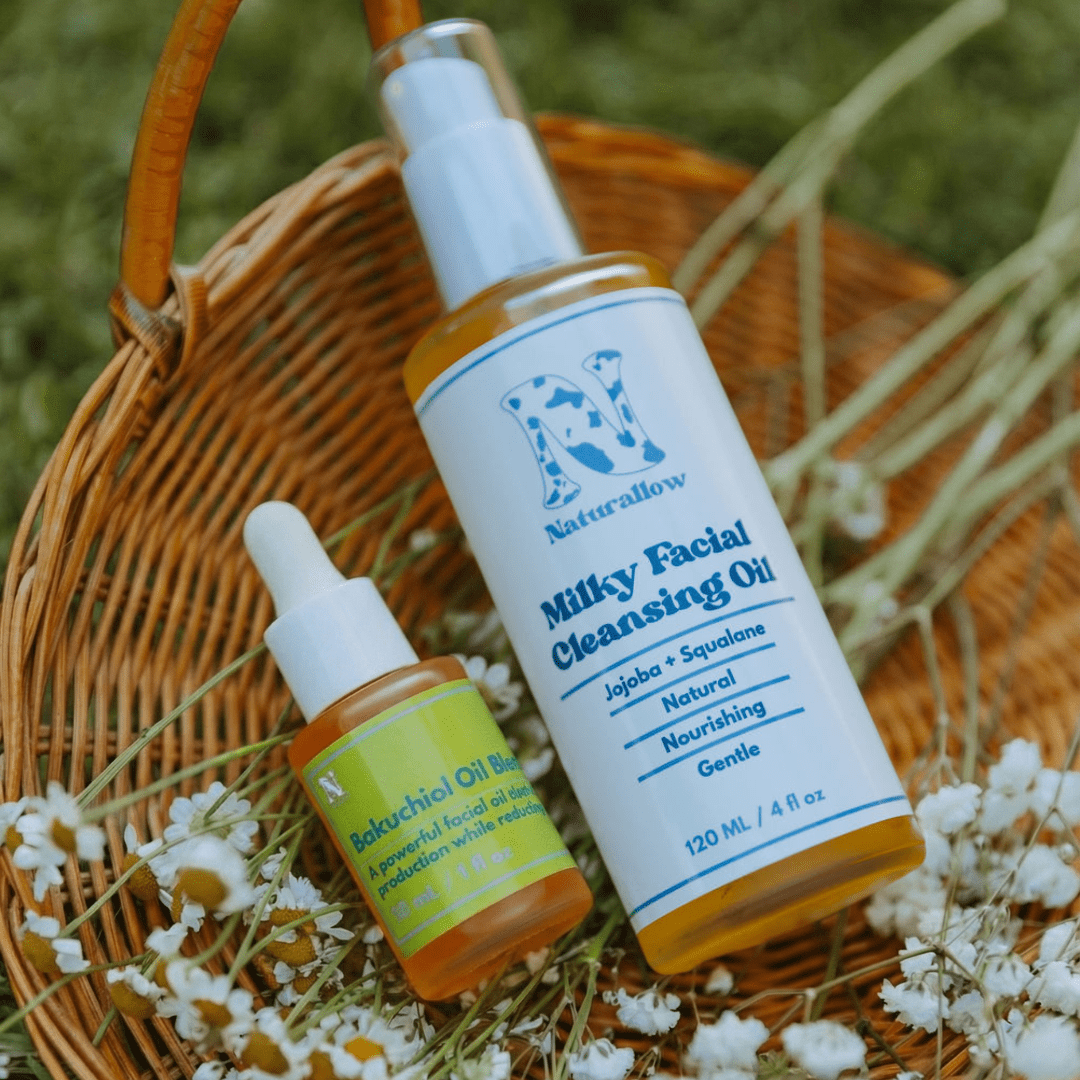 Naturallow's Cleanse and Treat Anti-Aging Oil Duo on a woven basket with flowers