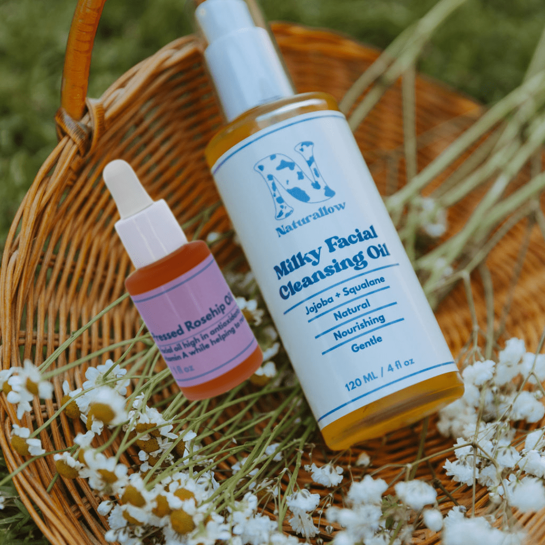 Naturallow's Organic Barrier Repair oil duo on a woven basket with flowers.