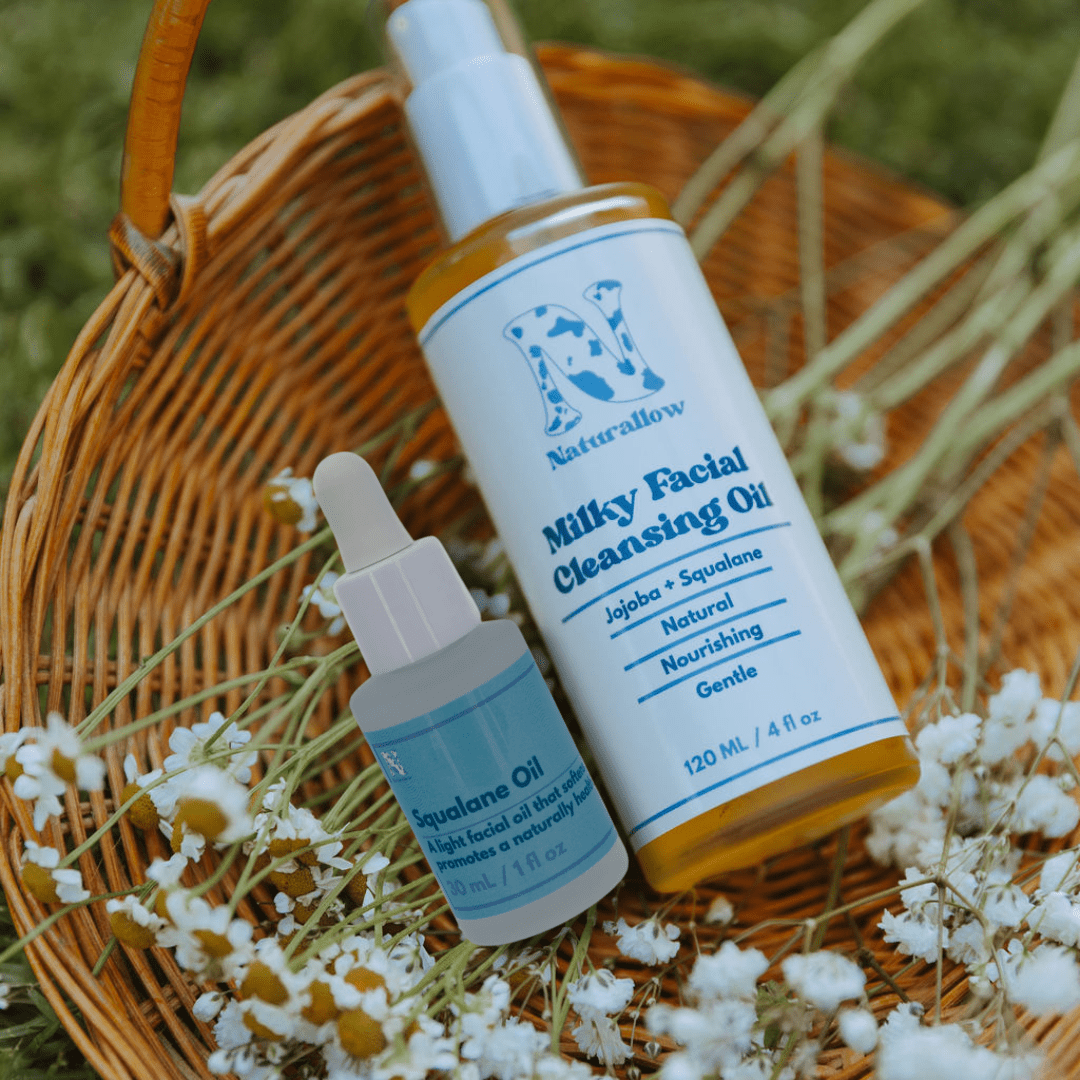 Naturallow's Non-Toxic Ultimate Skin Hydration Oil Duo for Dry, Sensitive Skin on a woven basket with flowers.