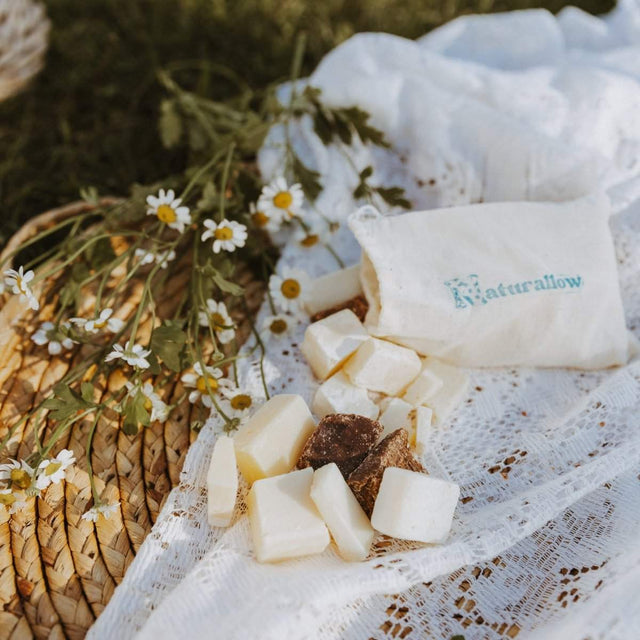 Naturallow's Soap Sample Sack spilling out on a white lace cloth on the ground