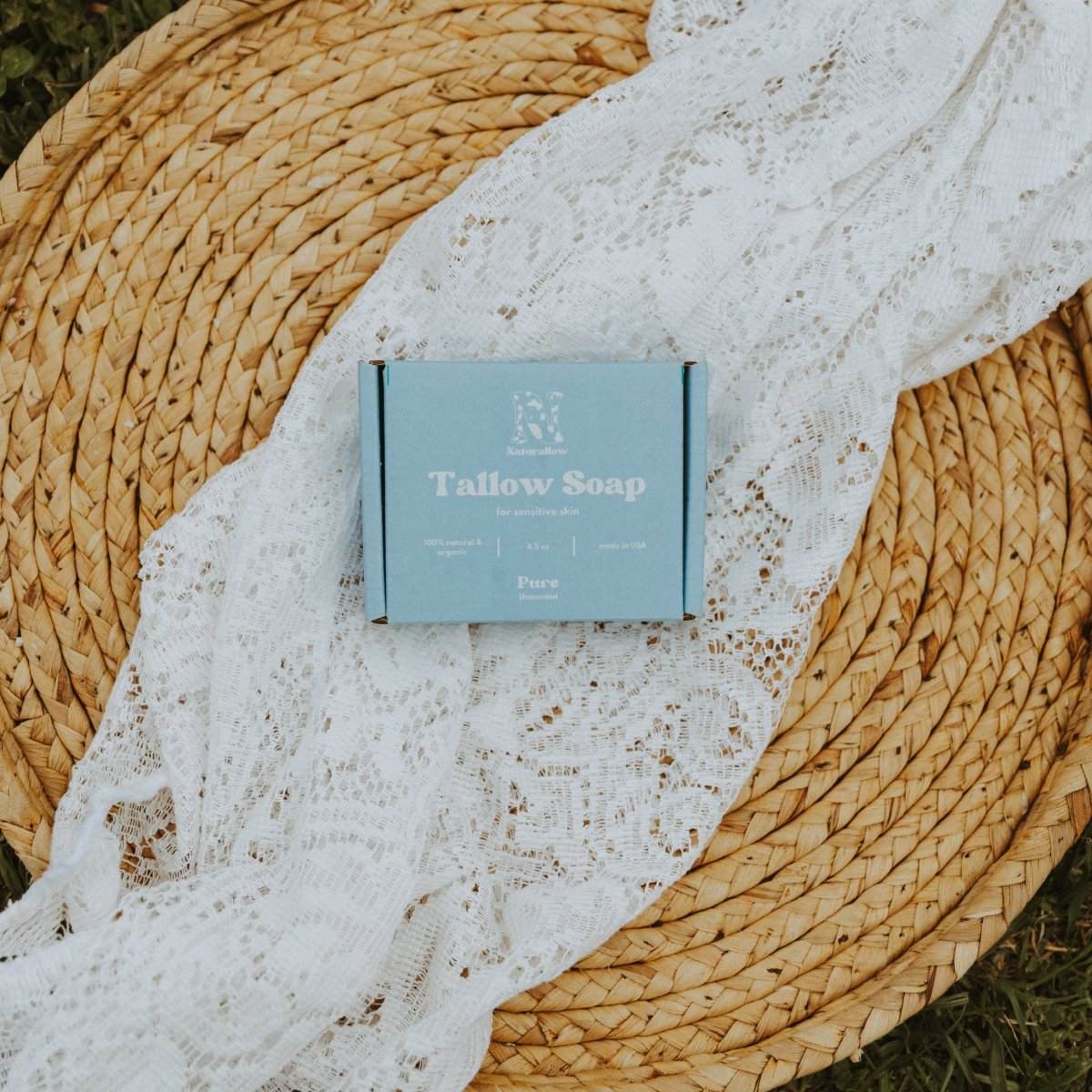Naturallow Pure Unscented Tallow Soap lying on a white lace cloth on top of a woven wooden basket