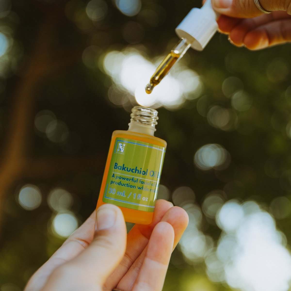 Naturallow's Bakuchiol Facial Oil Retinol Alternative with a dropper against a green canopy background