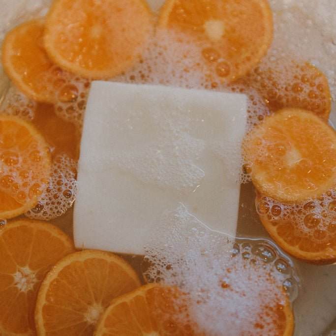 Naturallow Tallow Soap Bar lathering in a pile of citrus slices