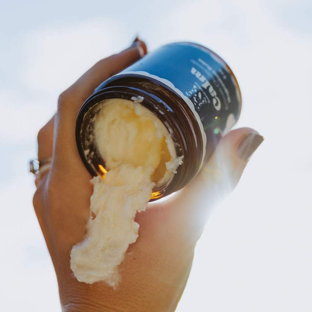 Naturallow's Tallow Magnesium Balm Jar being tipped upside-down in a with the contents pouring out