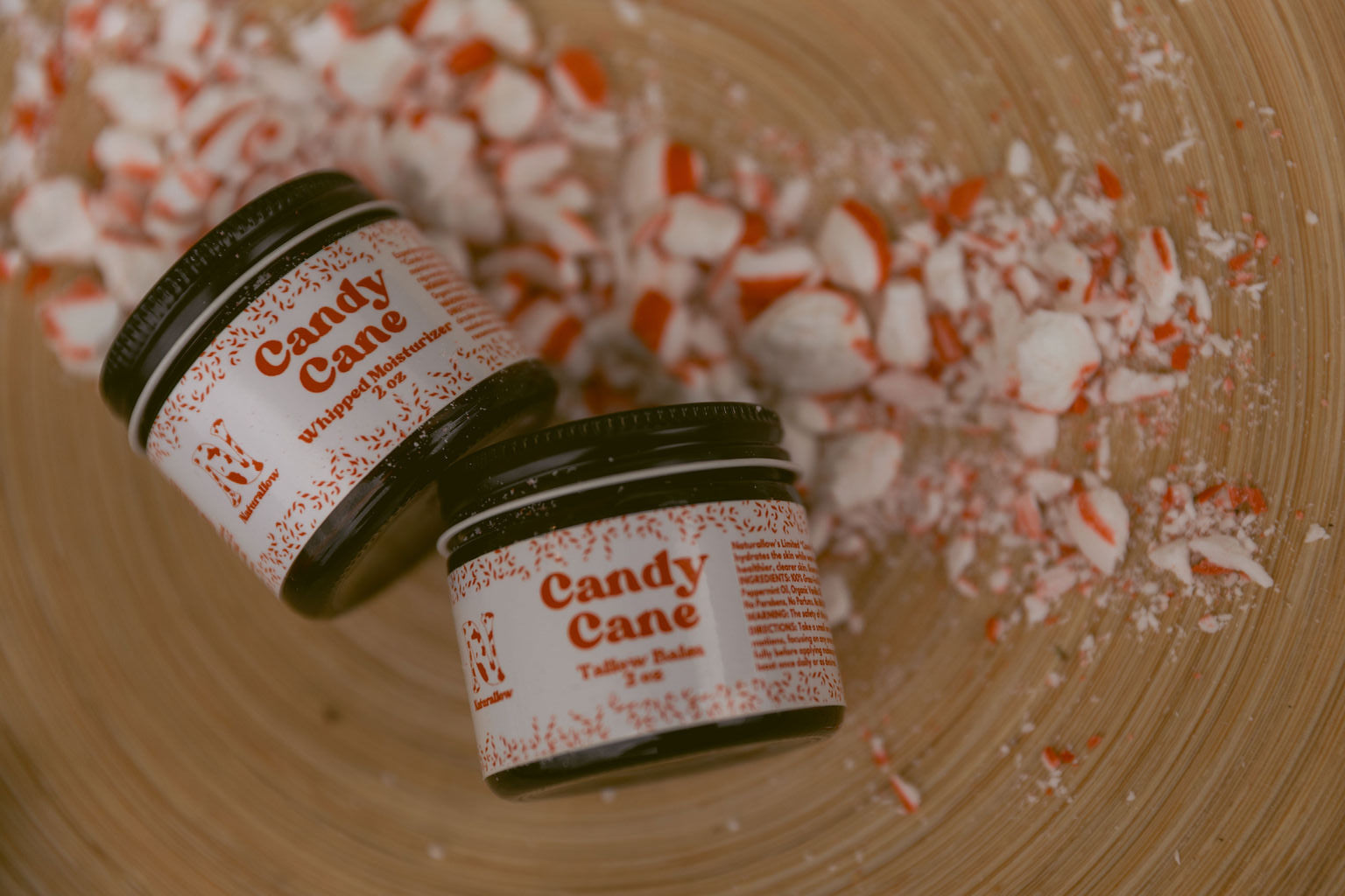Naturallow Limited Edition Candy Cane Moisturizers on a bed of crushed peppermint