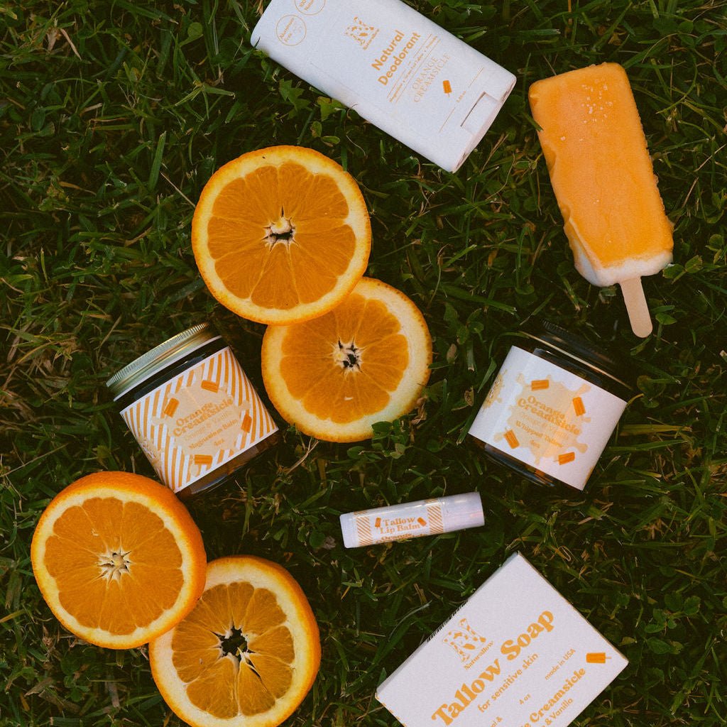 Naturallow's Complete Orange Creamsicle Collection in the grass with orange slices
