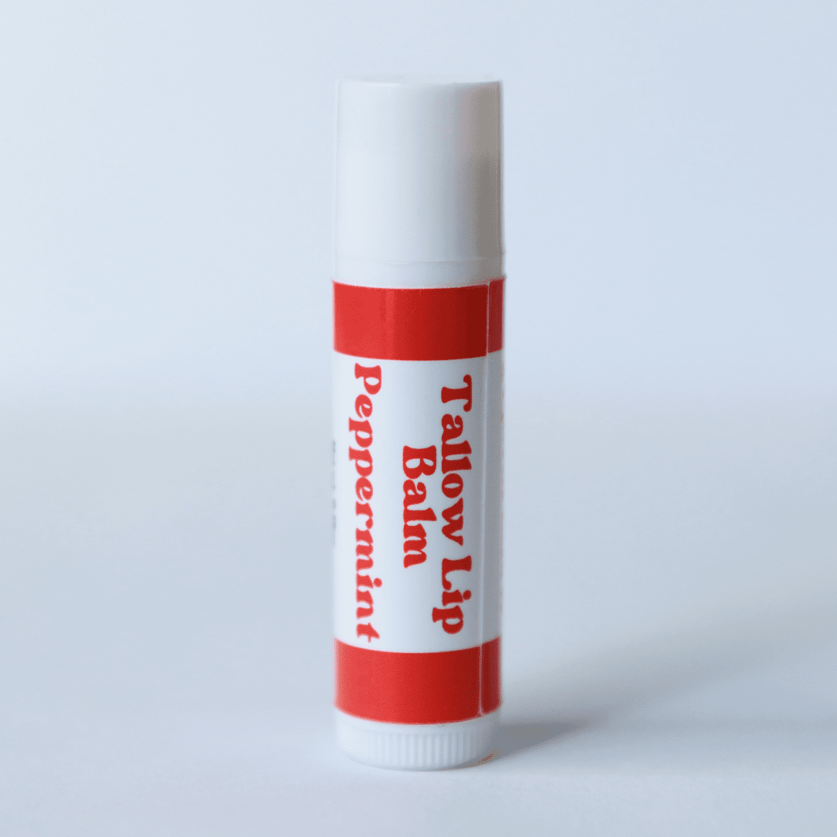 Naturallow's Peppermint Tallow Lip Balm Standing against a White Background